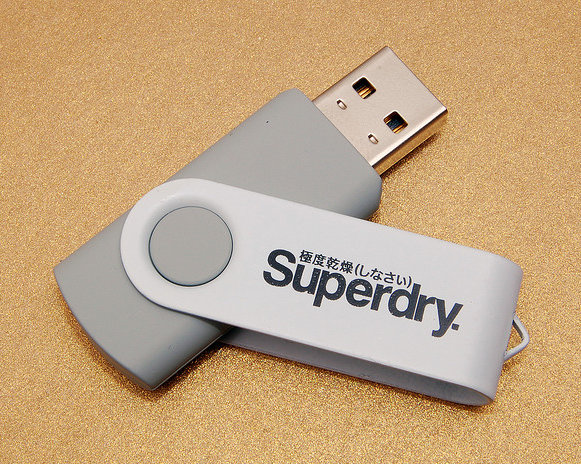 A USB memory stick bearing the Superdry 極度乾燥（しなさい） logo