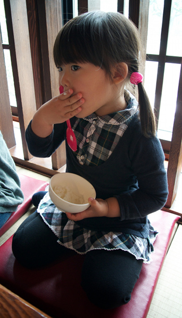 A girl kneeling down in a restaurant
