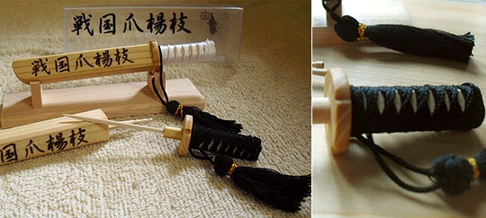 A cocktail stick holder modelled on a samurai sword and scabbard