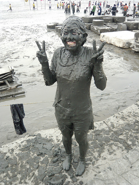 A woman totally covered in mud at the Kashima Gatalympics
