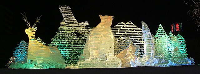 A giant sculpture of wildlife made out of ice and illuminated