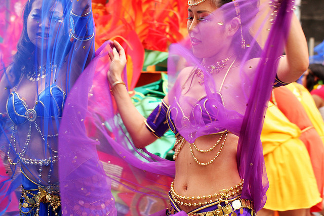 Samba performers in blue and purple two-part costumes