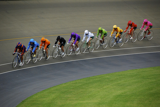 A line of cyclists following a pacer during a keirin race