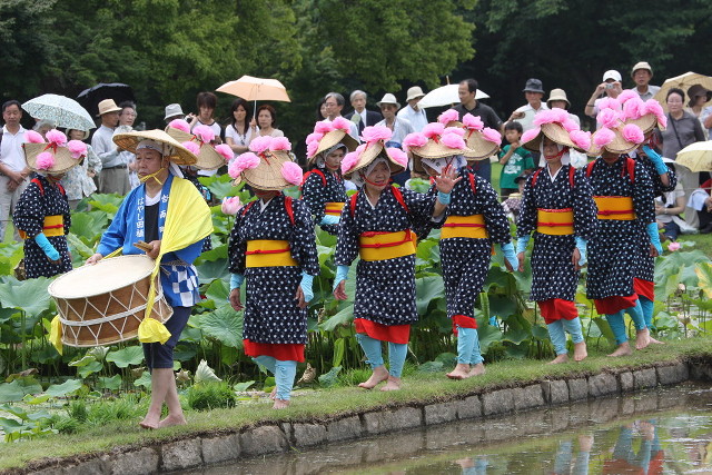 Women led by a drummer, heading out to plant rice at an Otaue Matsuri in Okayama City