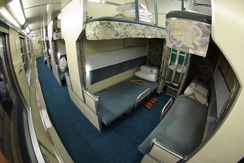 Bunks line one side of a train carriage