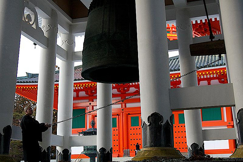 A monk rings a giant bell in a Koyasan temple